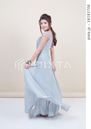 Full length of beautiful female model holding a 38283706