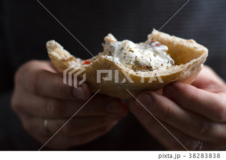 Man is holding a bite of a fajita close-up Man is holding a bite of a fajita close-up 38283838