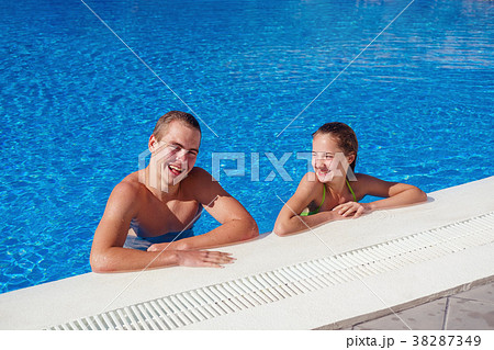 boy and girl having fun in swimming pool boy and girl having fun in swimming pool 38287349