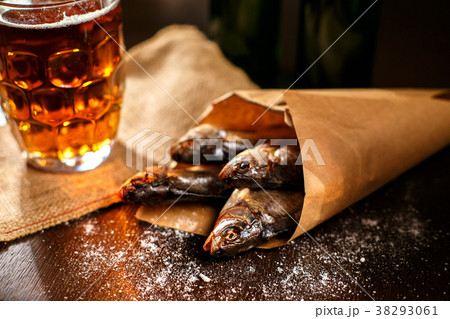 dried fish and vintage glass of beer on a black 38293061