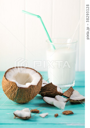 Glass of coconut milk on blue wooden table Glass of coconut milk on blue wooden table 38293128