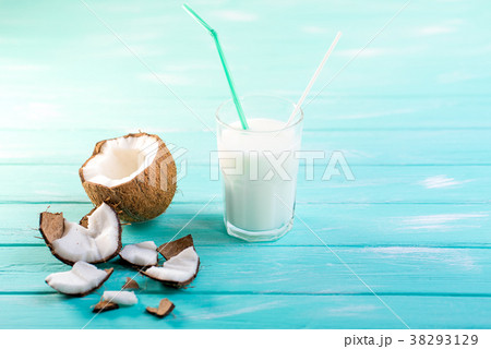 Glass of coconut milk on blue wooden table Glass of coconut milk on blue wooden table 38293129
