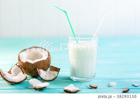 Glass of coconut milk on blue wooden table Glass of coconut milk on blue wooden table 38293130