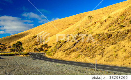 Curved road in the hills at sunset 38293266