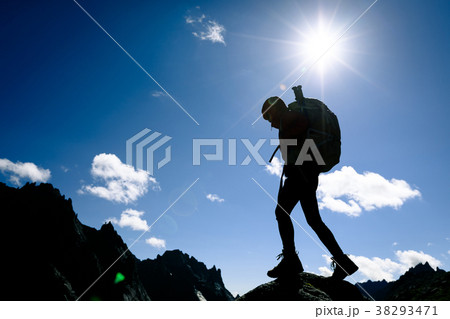 silhouette of woman hiking on sunrise mountain top 38293471