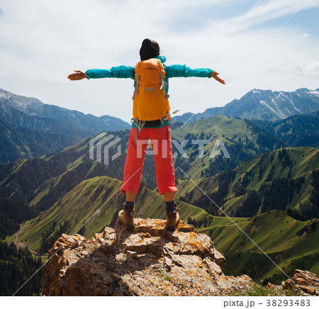 woman enjoy the view on top of mountain rock woman enjoy the view on top of mountain rock 38293483