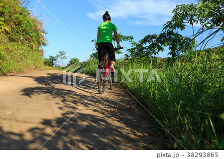 cyclist riding mountain bike on country road cyclist riding mountain bike on country road 38293865