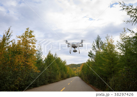 drone flying in the air over autumn forest 38297426