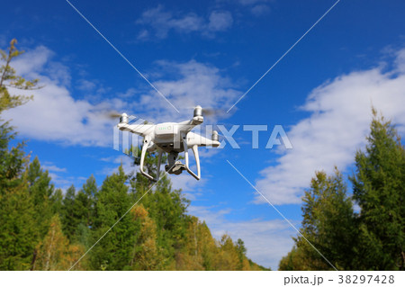 one drone flying in the air over autumn forest one drone flying in the air over autumn forest 38297428