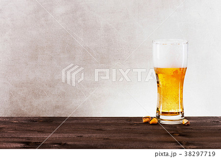 Glass of light beer on the wooden table Glass of light beer on the wooden table 38297719
