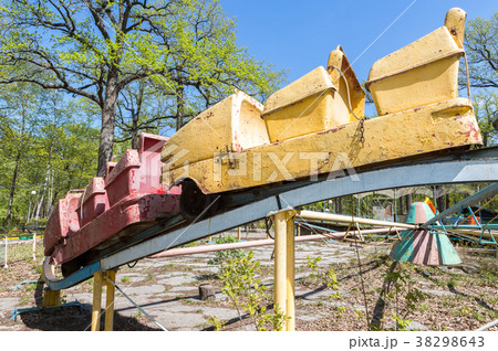 Old rusty carousel in a summer public park Old rusty carousel in a summer public park 38298643