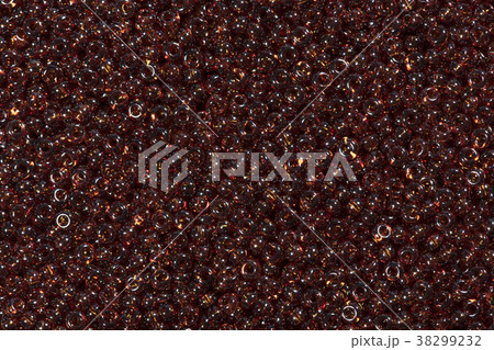 Close up of saddle brown seed beads. Close up of saddle brown seed beads. 38299232