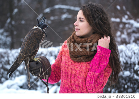 A woman communicates with a bird 38301810