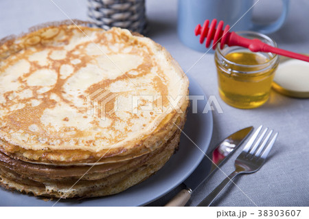 Traditional Russian pancakes with honey. Traditional Russian pancakes with honey. 38303607