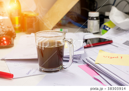 Hot coffee on the desk on a busy day 38303914