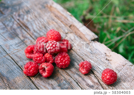 Raspberries on a wooden surface 38304003