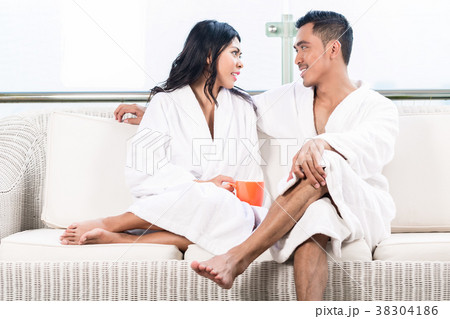 Couple in morning sitting on couch Couple in morning sitting on couch 38304186