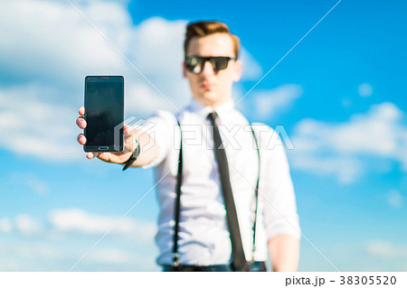Young busunessman in white shirt, tie, braces and 38305520
