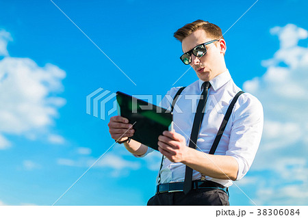 Attractive busunessman in white shirt, tie, braces Attractive busunessman in white shirt, tie, braces 38306084