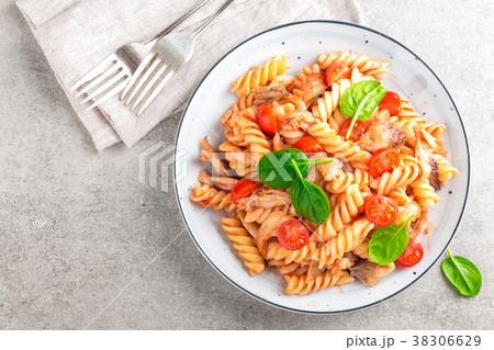 Pasta spirali stirred with fried pieces of chicken Pasta spirali stirred with fried pieces of chicken 38306629