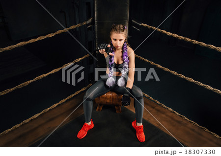 Boxing fashion girl on break sits on a chair 38307330