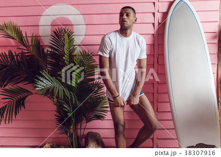 Sexy man in a white T-shirt is near the beach 38307916