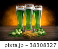 three glasses of green beer with barley and hops 38308327