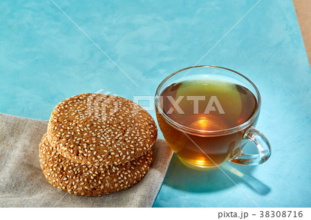 Glass cup of tea and oatmeal chocolate cookies Glass cup of tea and oatmeal chocolate cookies 38308716