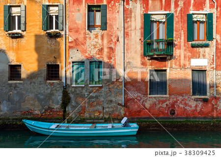 Old house and boat on canal in Venice, Italy. 38309425