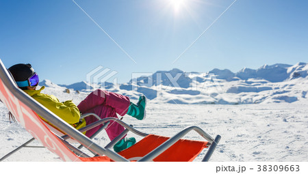Image of sporty woman in helmet sitting at snowy Image of sporty woman in helmet sitting at snowy 38309663