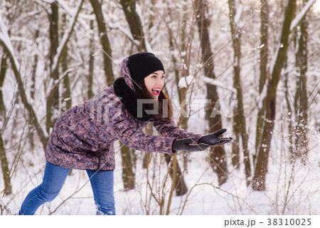 Young expressive woman throw the snow outdoors Young expressive woman throw the snow outdoors 38310025