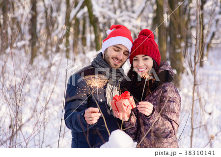 Couple in red hats holding gift and bengals 38310141