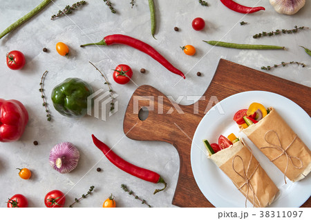 A tasty vegetable burrito on a plate A tasty vegetable burrito on a plate 38311097