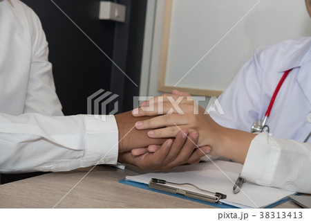 doctor holding patient hand & comforting him for bad news. physician support & encourage a man for medical examination. encouragement & empathy concept 38313413