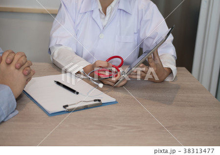 doctor showing test result on tablet to patient at hospital. physician talk & give advice to man about his health at medical office doctor showing test result on tablet to patient at hospital. physician talk & give advice to man about his health at medical office 38313477