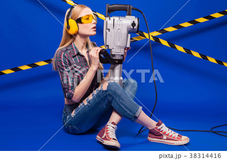 Pretty builder girl in chechered shirt, jeans and Pretty builder girl in chechered shirt, jeans and 38314416