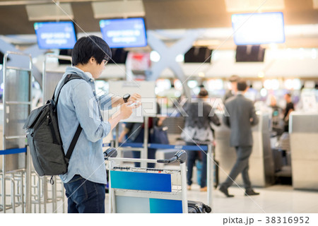 Young Asian man waiting for airport check in 38316952