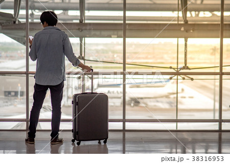 Young man and suitcase luggage in airport terminal 38316953