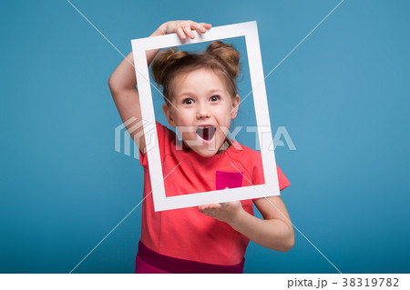 Beautiful cute little girl in pink dress holds 38319782