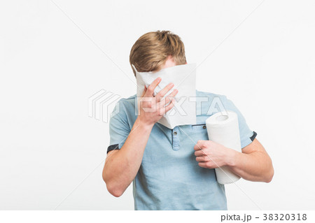 Young man has a runny nose on white background Young man has a runny nose on white background 38320318