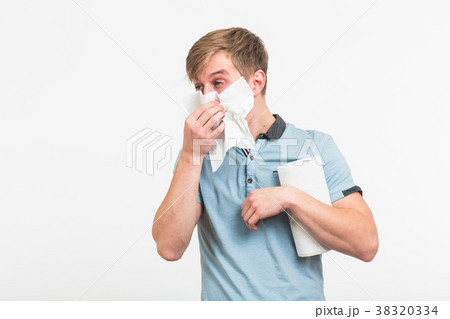 Young man with handkerchief. Sick guy isolated has 38320334