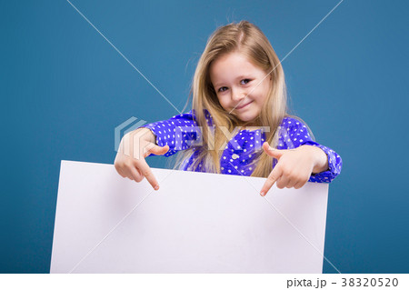 Cute little girl in purple dress holds empty 38320520