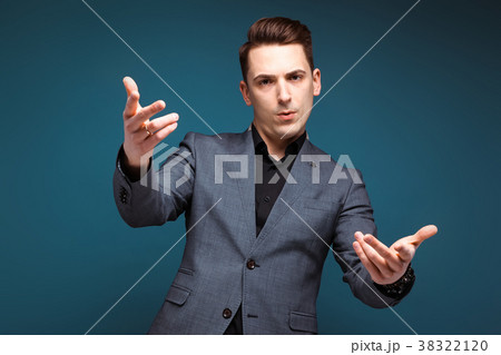 Young handsome businessman in grey jacket and Young handsome businessman in grey jacket and 38322120