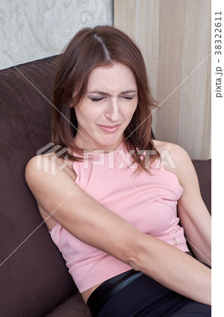 young woman suffering from pain in foot while young woman suffering from pain in foot while 38322611