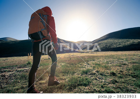 woman hiker hiking in sunrise mountains woman hiker hiking in sunrise mountains 38323933