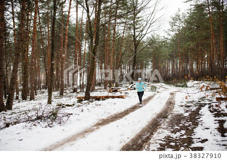 Senior woman jogging in winter nature. Senior woman jogging in winter nature. 38327910