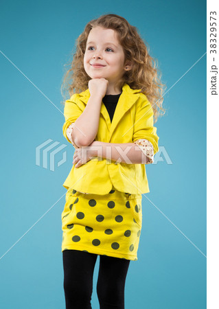 Cute young girl dressed all in yellow 38329573