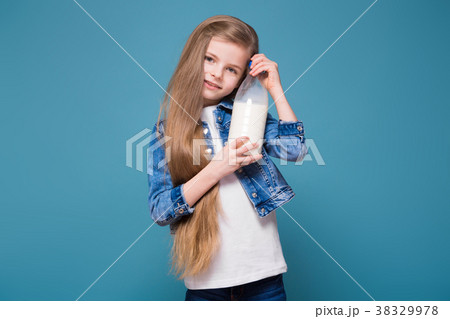 Little pretty girl in jean jacket with long brown 38329978