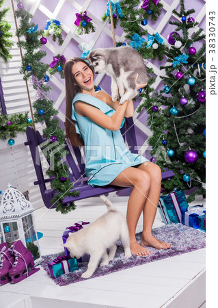 beautiful girl in a turquoise dress sitting on a 38330743