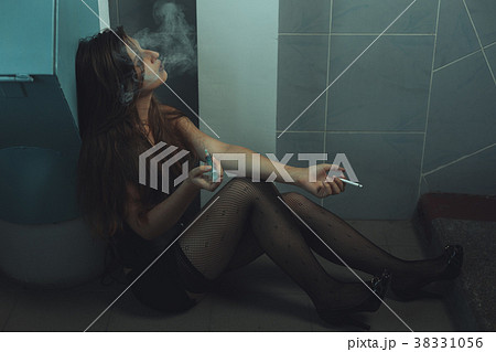 Woman drug addict makes an injection. 38331056